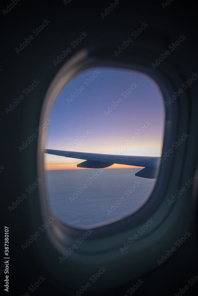 view out of an airplane window, beautiful sunset view out of an airplane window, beautiful sunset