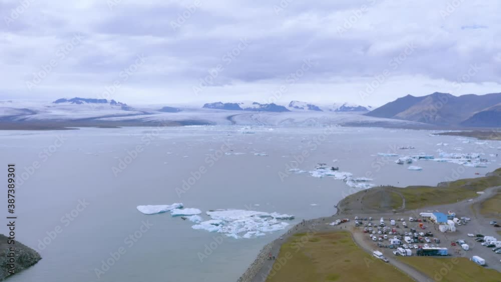 Birds eye view of Jokulsarlon lake, Iceland showing small icebergs floating on water surrounded by snow laden mountains. Birds eye view of Jokulsarlon lake, Iceland showing small icebergs floating on water surrounded by snow laden mountains.