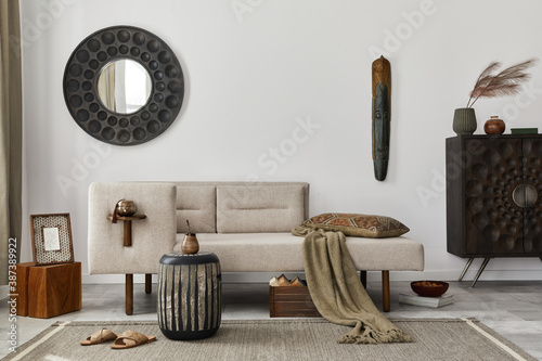 Modern ethnic living room interior with design chaise lounge, round mirror, furniture, carpet, decoration, stool and elegant personal accessories Fototapeta