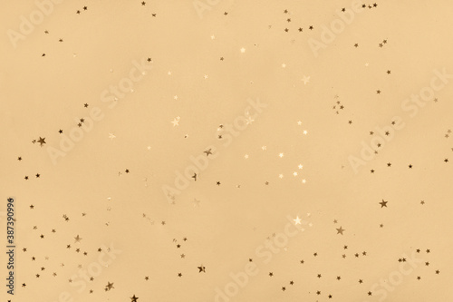 Scattered glitter on a biege color background, Christmas, New year decorations.