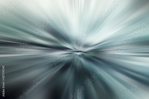 abstract blue light background with stripes of multicolored rays moving from the center, the concept of speed, movement