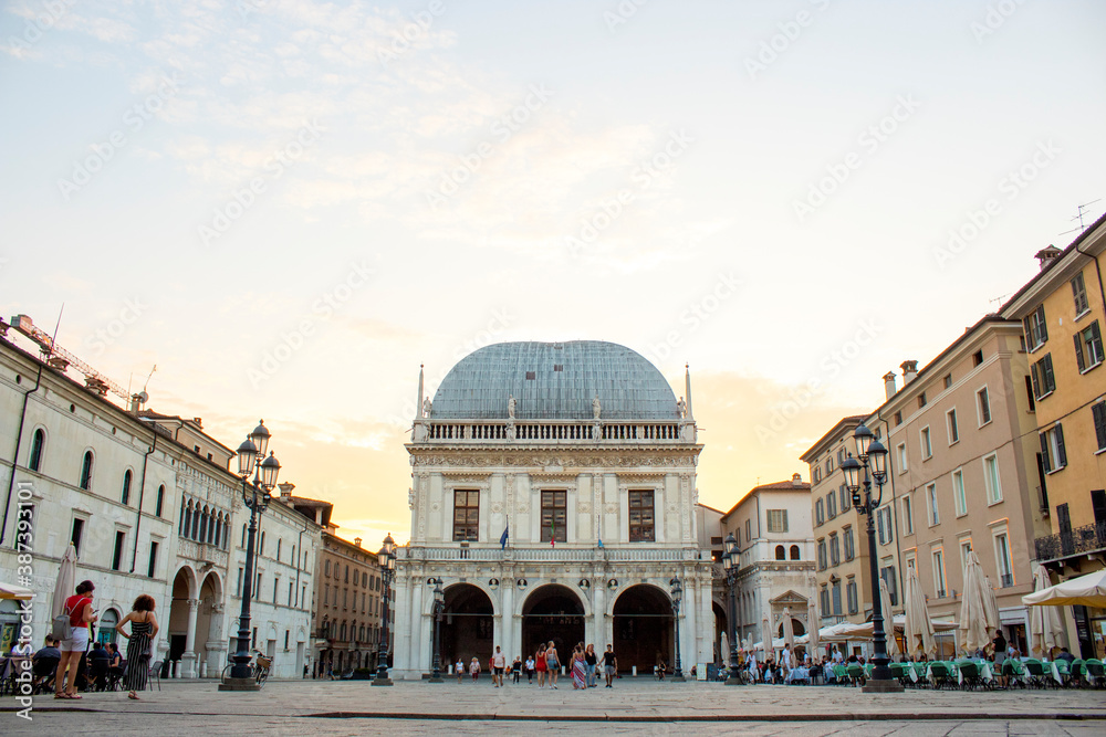 Panoramic view of Loggia palace ( palazzo della loggia) of Brescia square during sunset at the end of the summer.