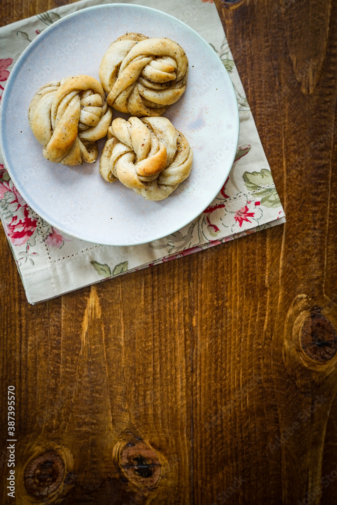 Fresh Swedish cardamom buns on a wooden background