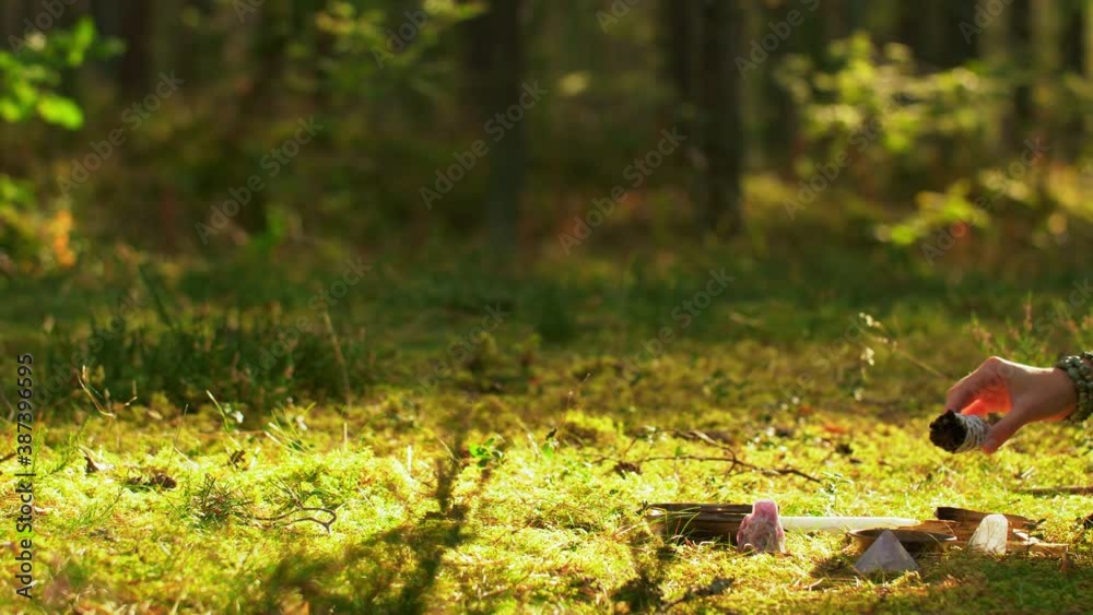 occult science and supernatural concept - young woman or witch with smoking white sage performing magic ritual in forest occult science and supernatural concept - young woman or witch with smoking white sage performing magic ritual in forest