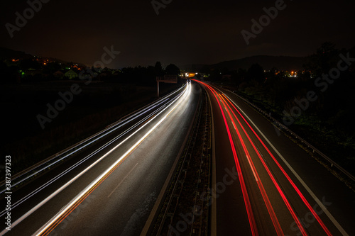 Motorway in night with red and white car light trails