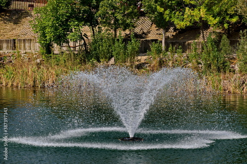 Fragment of artificial pond and fountain with beauty drops in residential district  Drujba  Sofia  Bulgaria  