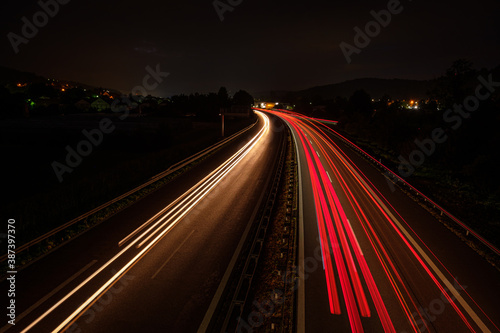 Many red car light trails on a road