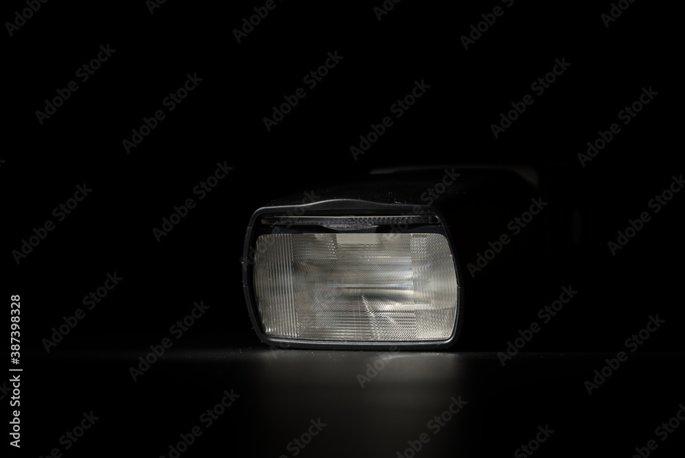 Flashlight head on black background in low key light Flashlight head on black background in low key light