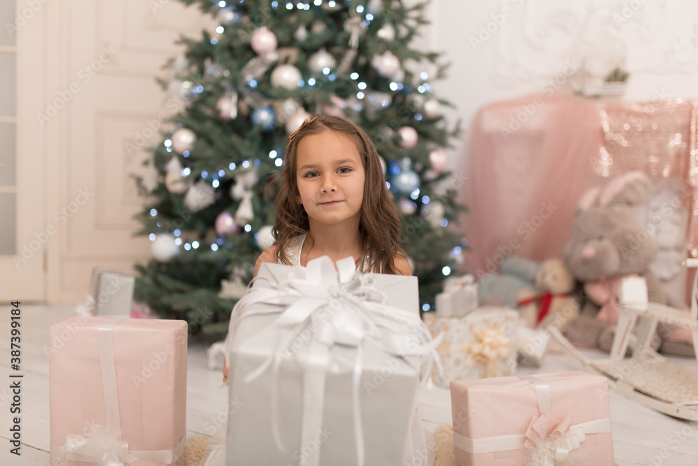 Happy childhood, magical Christmas tale. Little princess with Santa's present for Christmas Happy childhood, magical Christmas tale. Little princess with Santa's present for Christmas