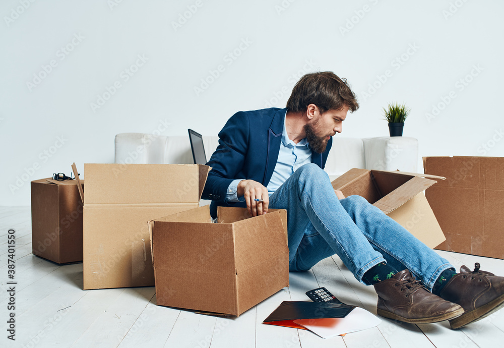 Business man picking up cardboard boxes and moving to a new place lifestyle Business man picking up cardboard boxes and moving to a new place lifestyle