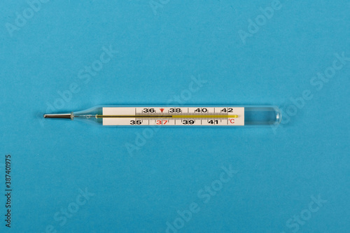 Medical thermometer on blue background