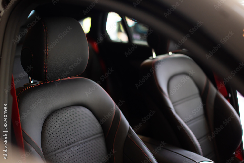 Close up and interior details of modern luxury sport cars. Comfortable leather cockpit seats inside luxury car.