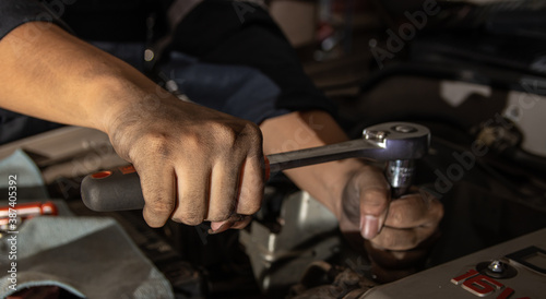 clossup the dirty hands of a auto mechanic is working