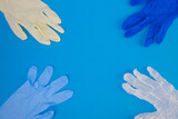 Multicolor latex gloves on blue background