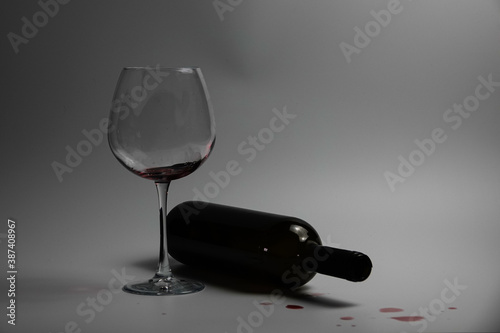 Goblet and Overturned wine bottle                               