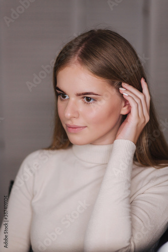 Portrait of beautiful blond hair woman with fresh dyed eyebrows. Female in beauty studio