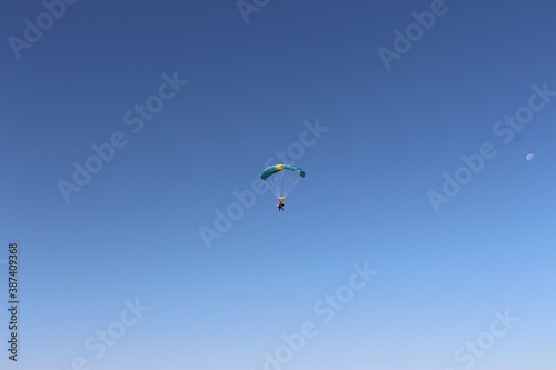 Fototapeta Naklejka Na Ścianę i Meble -  Person falling from the sky by parachute