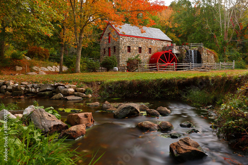 The Wayside Inn Grist Mill with water wheel and cascade water fall in Autumn.  photo