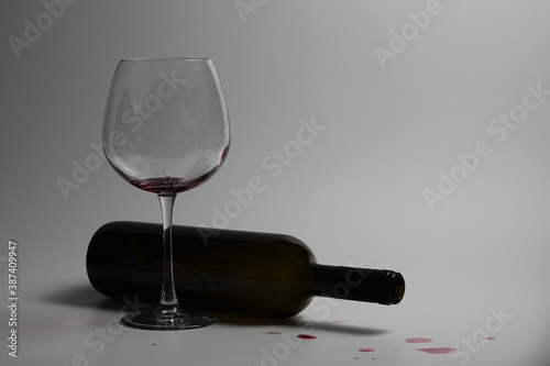 Goblet and Overturned wine bottle                               