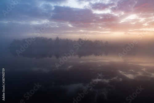 Misty morning in swamp lake