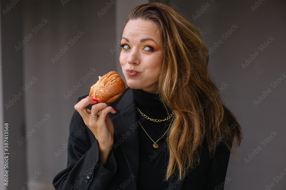 Woman in black clothes jacket with a chain around her neck Woman in black clothes jacket with a chain around her neck