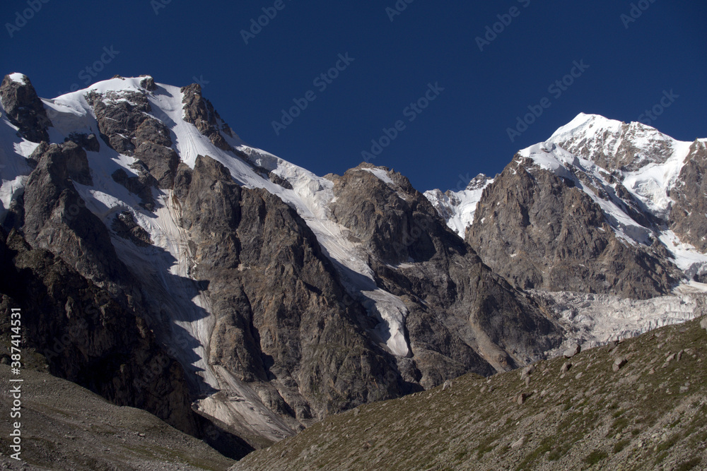 Mountain range with peaks covered with snow and glaciers. Kabardino-Balkarian natural reserve. Caucasus, Russia.