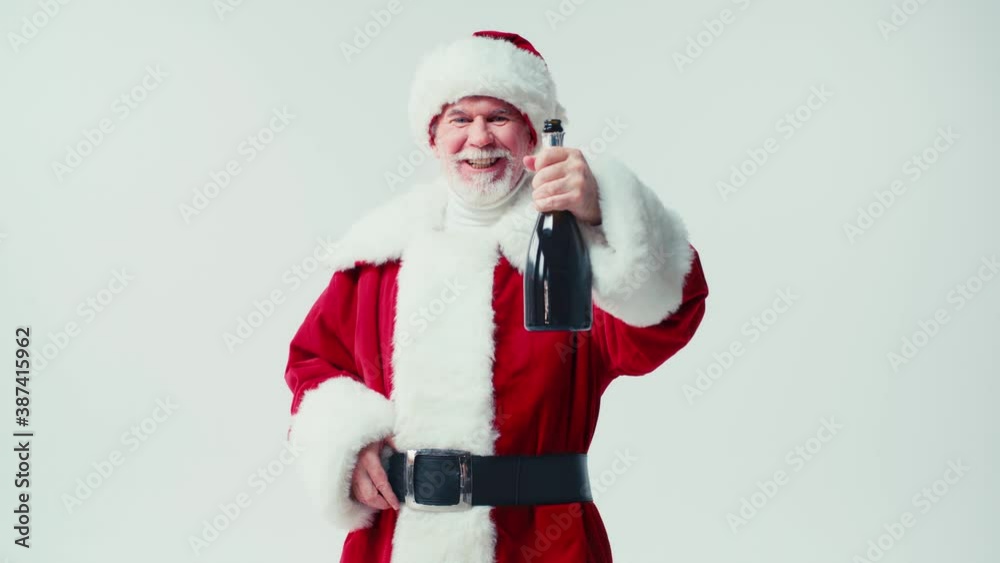 cheerful santa claus showing champagne bottle at camera isolated on white cheerful santa claus showing champagne bottle at camera isolated on white
