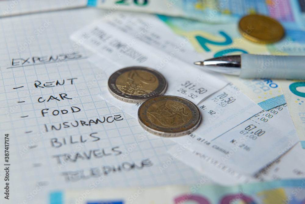 List of daily living expenses, with receipts, notes and coins next to