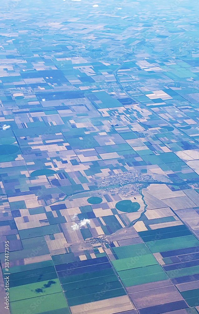 Fototapeta premium The view from the airplane window to the ground. Landscape view from the sky