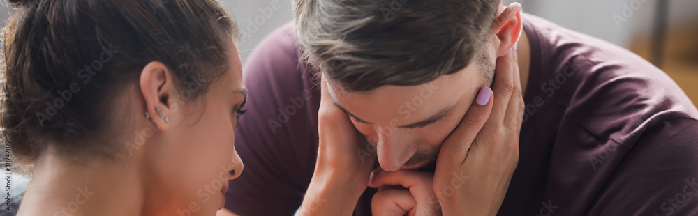 young woman touching head of depressed man, banner young woman touching head of depressed man, banner