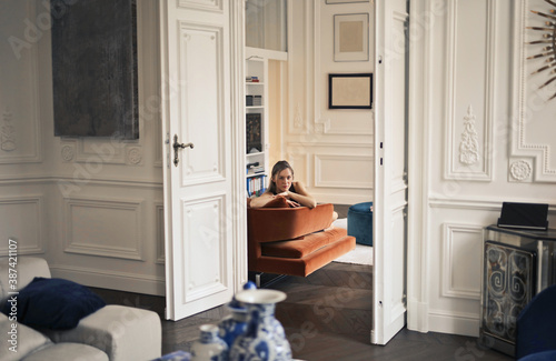 woman sitting on a sofa in a beautiful apartment photo