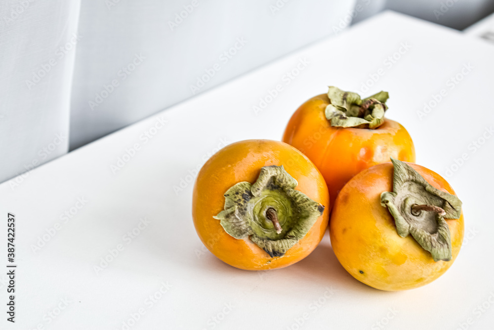 Ripe persimmon on a white background. Top view.