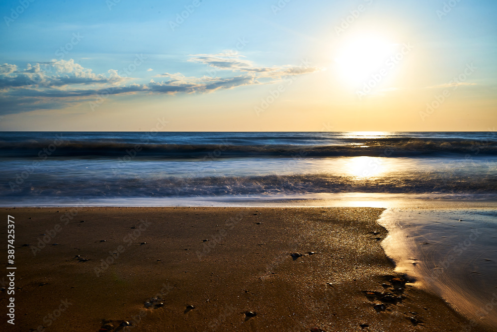 Sea sunset. Quiet calm sea. Sand beach.