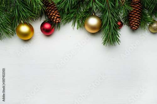 Christmas tree branches and christmas toys on a wooden background copy space