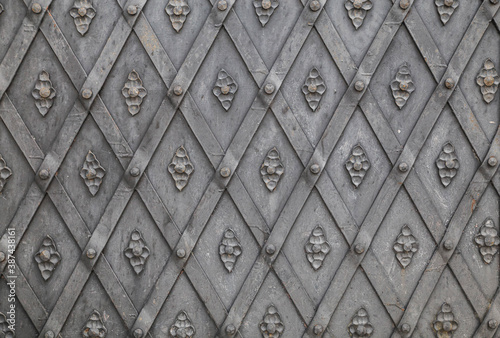 background of ancient metal forged doors in the castle