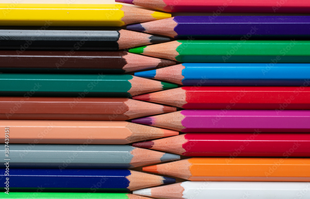 Macro view of some color pencils in front of each other, making a zipper effect.