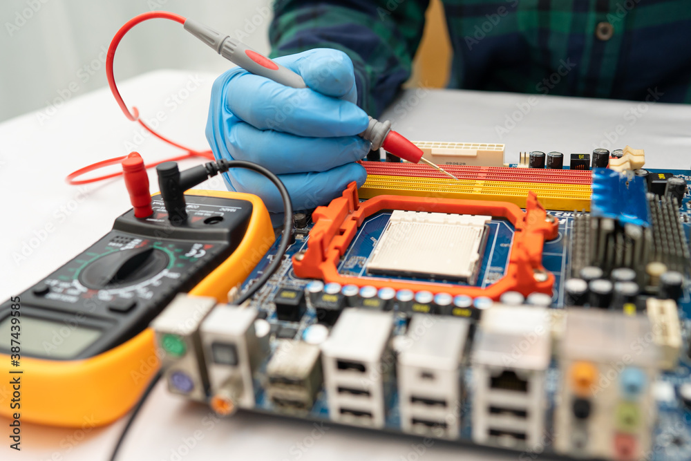 technician repairing inside of hard disk by soldering iron. Integrated Circuit. the concept of data, hardware, technician and technology. technician repairing inside of hard disk by soldering iron. Integrated Circuit. the concept of data, hardware, technician and technology.