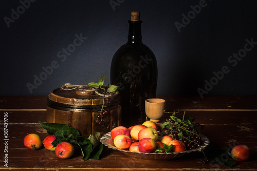 Fototapeta Naklejka Na Ścianę i Meble -  still life, Krynka, apples, tree, basket, red, walnuts, table, brown, fruit, white, cloth, bottle, red currant, barrel