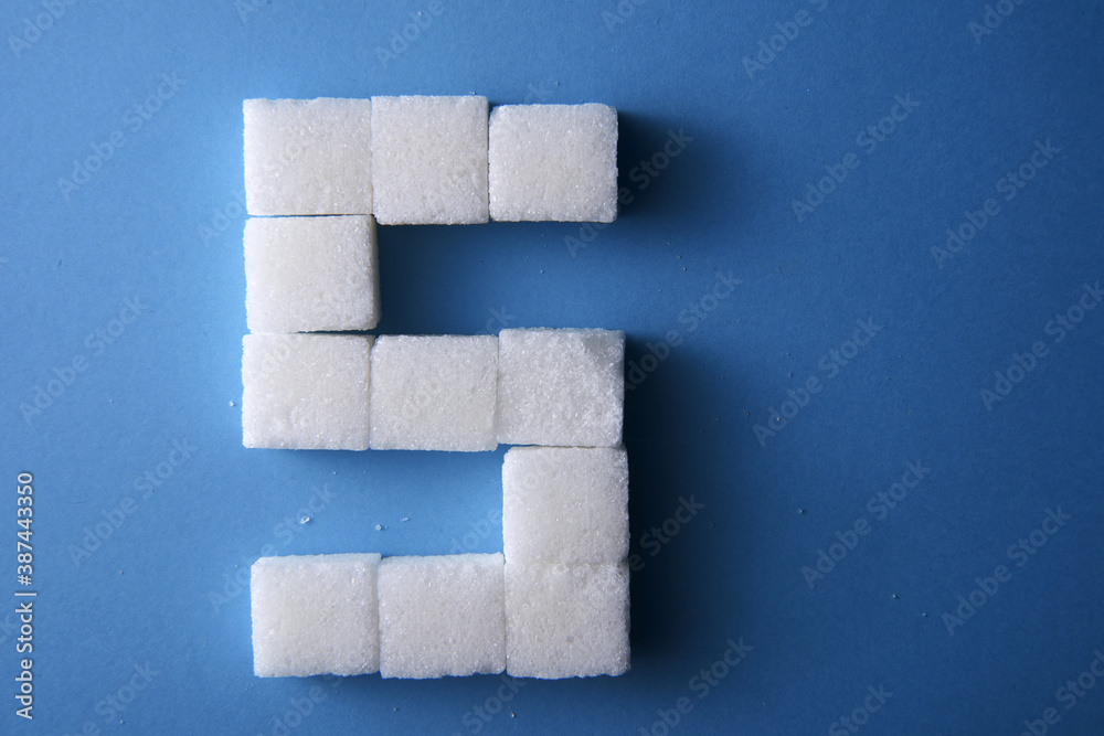 top view alphabet s of white sugar cube on blue background top view alphabet s of white sugar cube on blue background