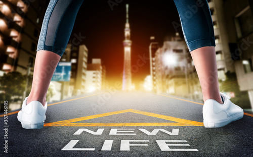 Photography Woman standing on New life road leading to Tokyo night city skyline for New begining concept