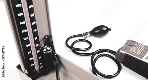 blood pressure machine for the patient showing the mercury tube with rubber pipes on white background.	