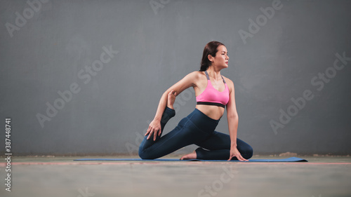 Portrait of gorgeous young women practicing yoga indoor. Calmness and relax, female happiness.