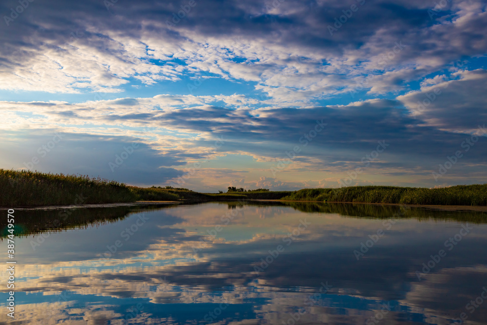 Fototapeta premium Silvery sunrise over a quiet lake.