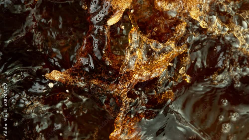 Super slow motion of splashing cola drink or ice tea. Filmed on high speed cinema camera, 1000 fps. Super slow motion of splashing cola drink or ice tea. Filmed on high speed cinema camera, 1000 fps.