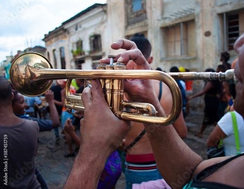 Men playing trumpet walking through the streets