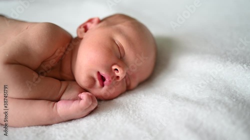 Cute emotional funny yawning newborn little baby boy sleeping in crib. Baby goods packaging template. Healthy child, concept of hospital and happy motherhood. Infant baby. Nursery.