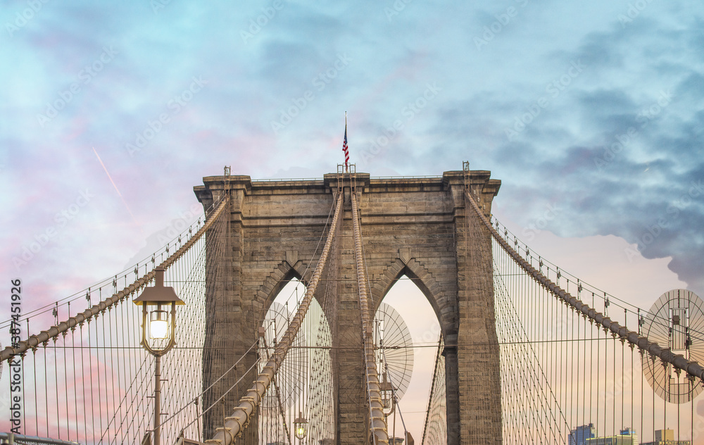 Fototapeta premium Sky colors on the background of Brooklyn Bridge Tower, New York City