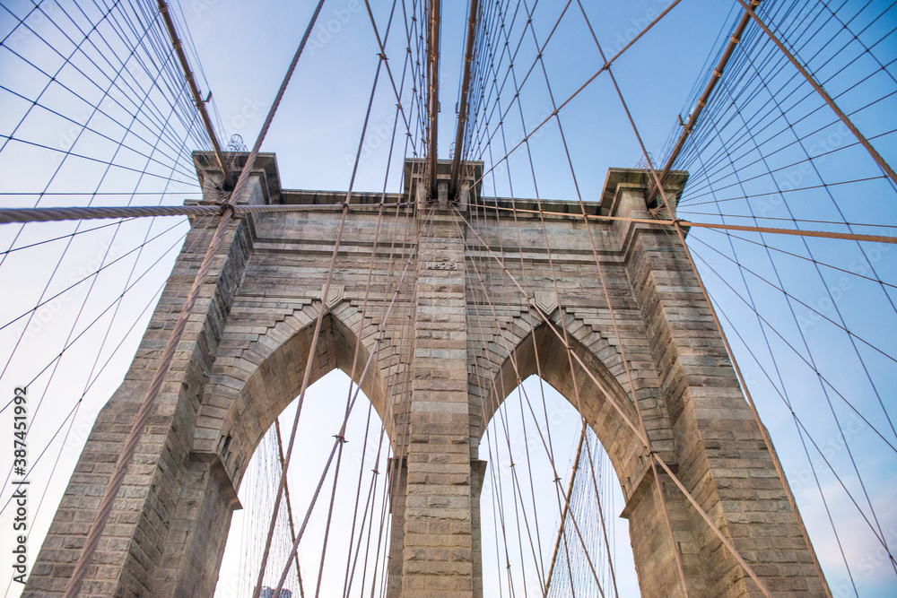 Naklejka premium Sunset colors of Brooklyn Bridge with giant tower