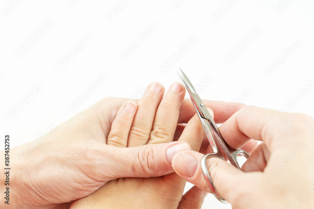mom cuts the nails of a small baby mom cuts the nails of a small baby