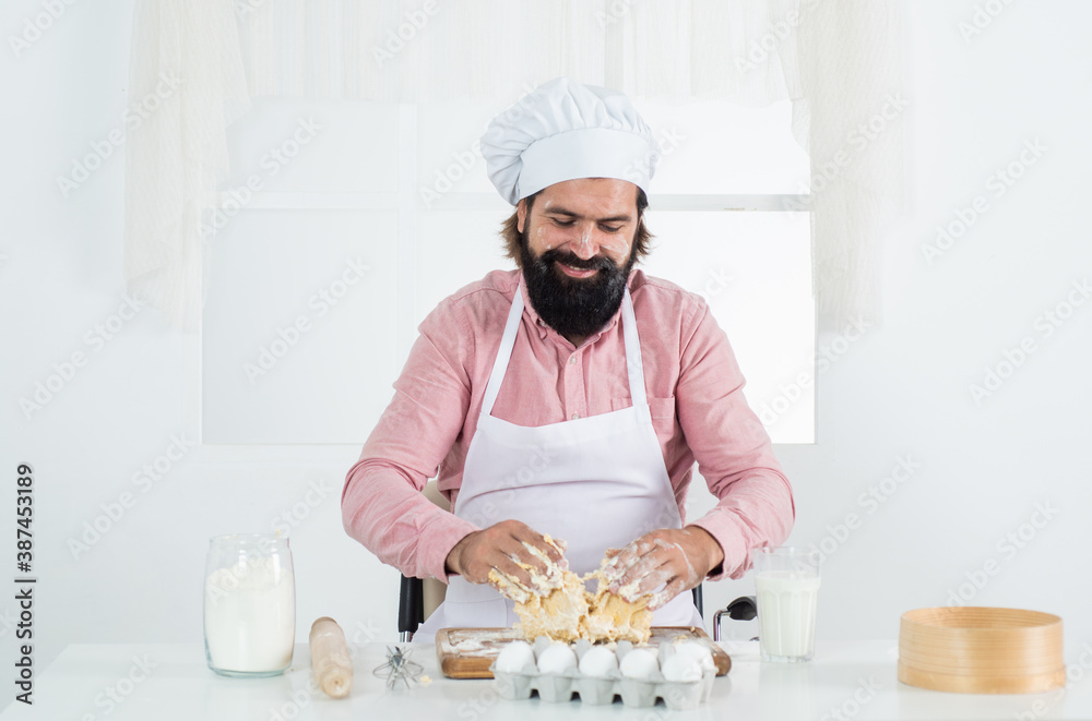 confident bearded man wear chef hat. male cook preparing food in home kitchen. brutal hipster in apron cooking meal. time for eating. happy baking. concept of housekeeping. making fresh dough confident bearded man wear chef hat. male cook preparing food in home kitchen. brutal hipster in apron cooking meal. time for eating. happy baking. concept of housekeeping. making fresh dough